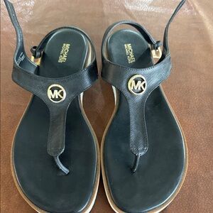 MICHAEL Michael Kors Black Leather T-Strap Sandals with Gold MK Emblem